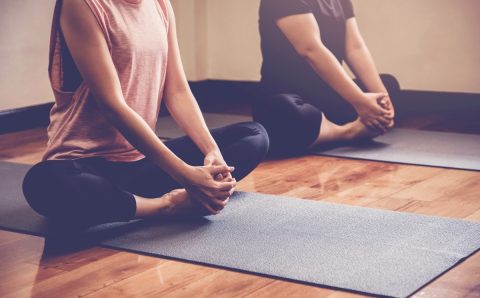 Optimized-group-young-healthy-asian-women-practicing-yoga-lesson-with-instructor-home-studio